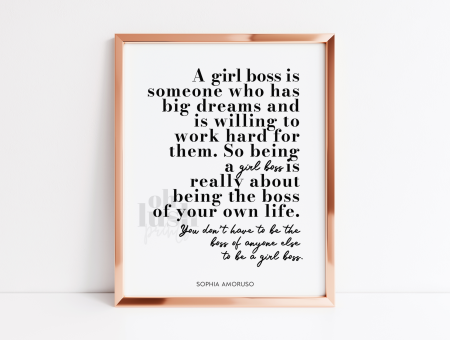 a shiny gold frame with a detailed quote inside about being a girl boss, by Sophia Ambruso.