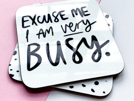cute handwritten design on a coaster, that reads 'excuse me I am very busy'.
