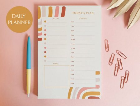 pastel coloured daily 'to do' planner with stationery and paperclips.
