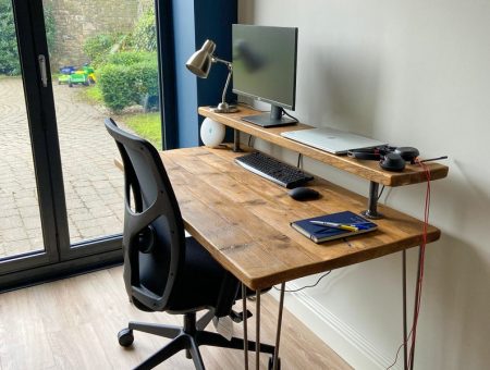Rustic Desk with Shelf and computer chair near two glass doors.