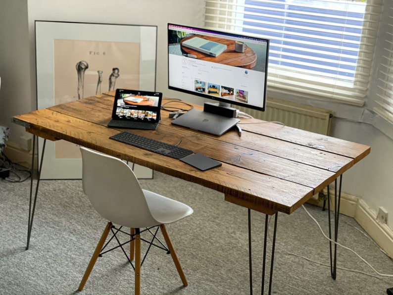 a wooden desk, handmade, with office equipment neatly on top.