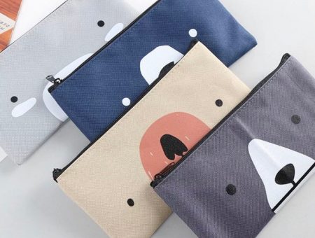 four cute bear face pencil cases in 4 different blue and grey shades.