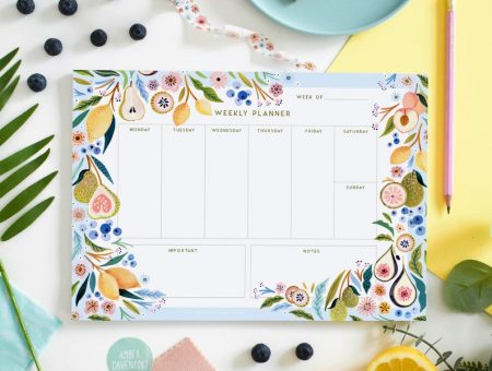 a detailed weekly planner with a botanical border.