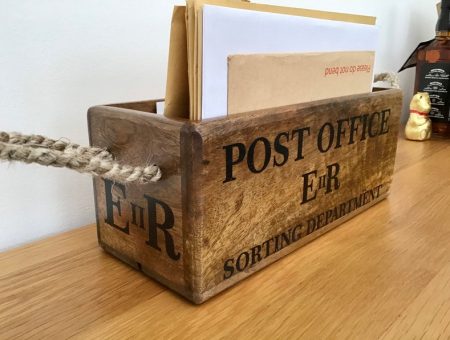 old fashioned wooden post office ER box for letter storage before posting, with rope handles.