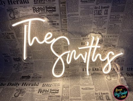 a shocking white neon sign for offices, this one reading 'the smiths' with black and white newspaper articles as a background.